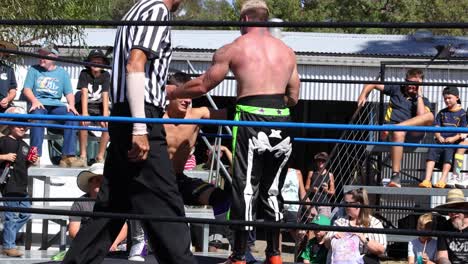 wrestlers compete in an outdoor wrestling ring