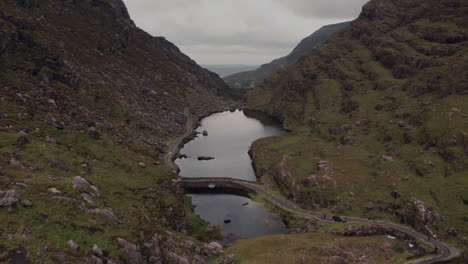 irish mountain valley with lake and road