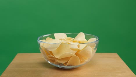 hands takes the chips from the bowl