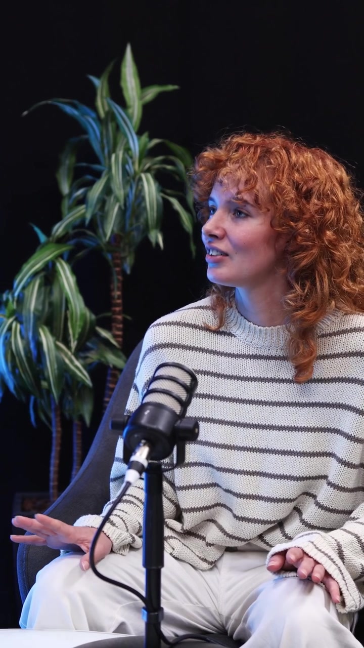 Young Woman with Red Curly Hair Speaking During a Podcast Interview