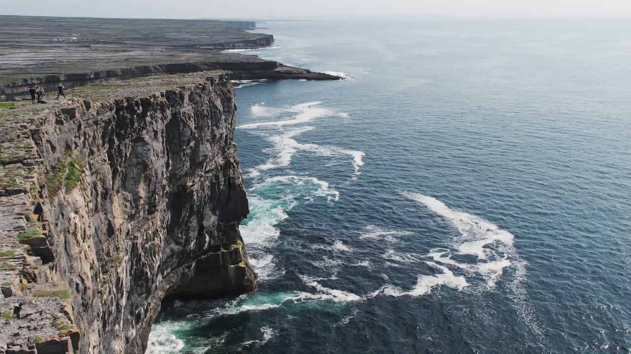 Tourists looking out on Inishmore Island cliffs