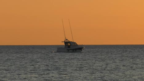 sport fishing boat cruising at dawn on silver sea, spain