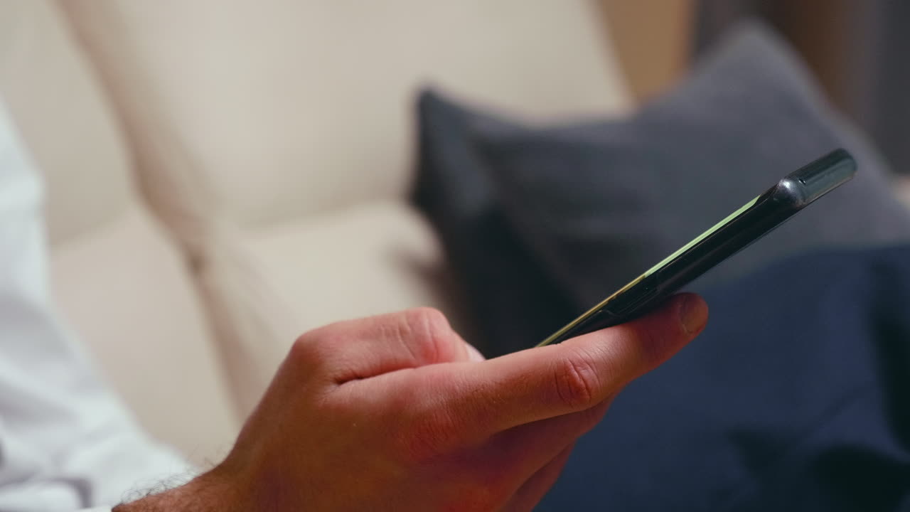 Close up of businessman browsing on smartphone
