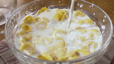 Crujientes-Copos-De-Maíz-Amarillo-En-El-Bol-Para-Por-La-Mañana-Un-Delicioso-Desayuno-Con-Leche.-Cámara-Lenta-Con-Seguimiento-De-Rotación.