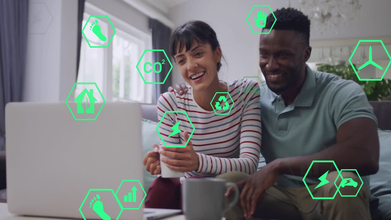 Couple sitting on couch watching laptop showing energy info, green hex icons guiding learning