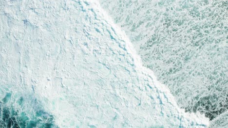 aerial top down view of extensive turquoise sea foam, big waves breaking