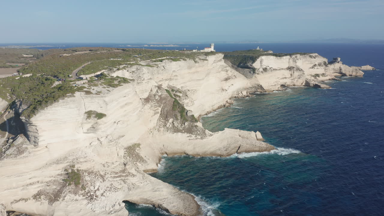 Bonifacio, Corsica aerial drone circling shot cliffs at day lighthouse rugged coastline limestone the turquoise Mediterranean Sea iconic French island landscape