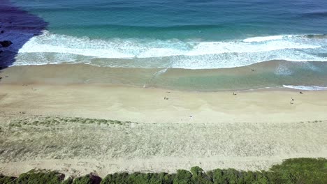 waves crushing onto a not very crowded beach in sydney australia