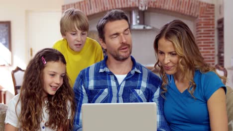 Happy-family-using-laptop