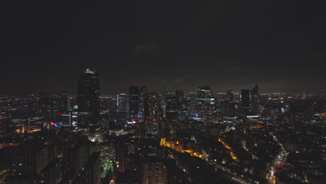 over the seine, paris' economic core stands proud, illuminated by both lights an