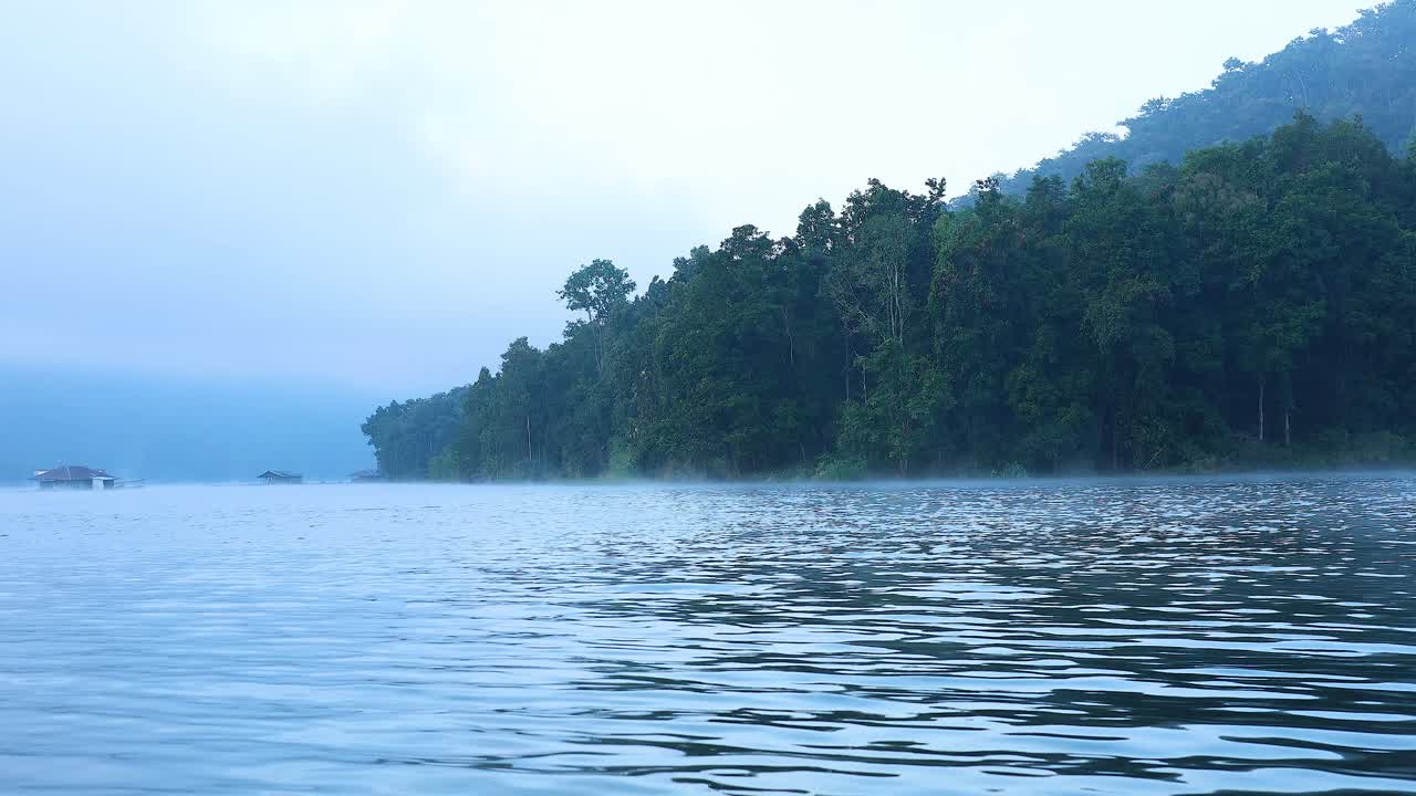 Serene river with misty mountain backdrop