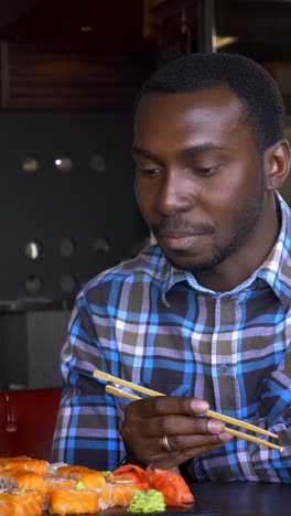 man eating sushi