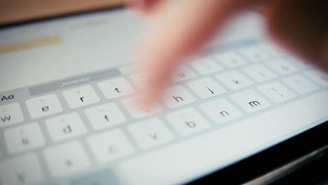 Woman-typing-on-tablet-keyboard---close-up