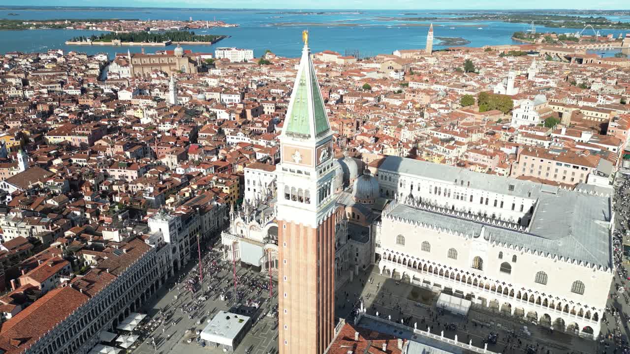 High-angle view of St. Mark's Bell Tower and Doge's Palace surrounded by Venice rooftops.