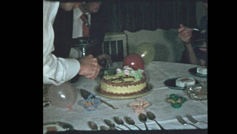 50's dad slices birthday cake for family