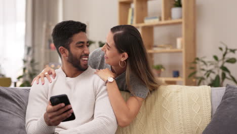 Phone,-kiss-and-couple-on-sofa-happy-in-home