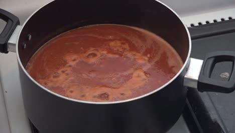 red sauce boiling on a pot