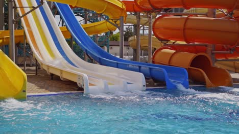 Waterslide in aquapark outdoor. Childs having fun in waterslide in aquapark