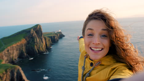 woman taking a selfie on a scenic coastal viewpoint