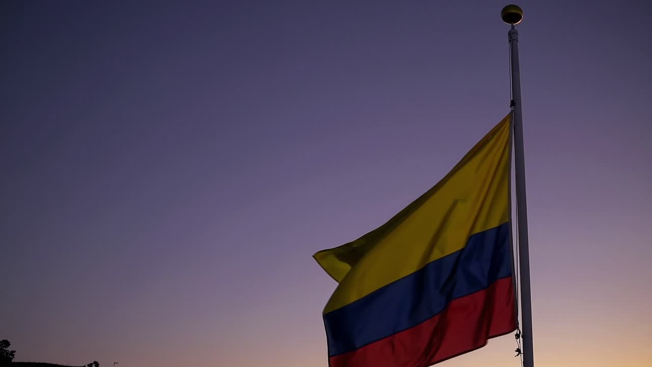 CGI of the Colombian flag waving in the wind at sunset, symbolizing national pride and the beauty of Colombia’s cultural heritage.