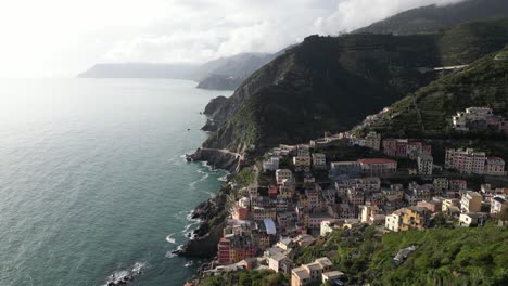 riomaggiore cinque terre italy aerial overhead flight tilt down shows dense homes