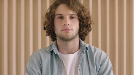 portrait of cute young man looking serious pensive at camera