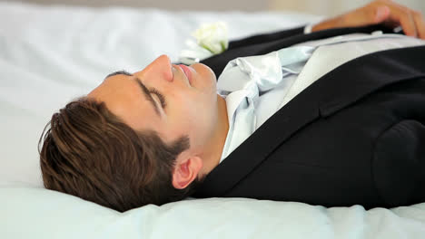 groom lying down before his wedding