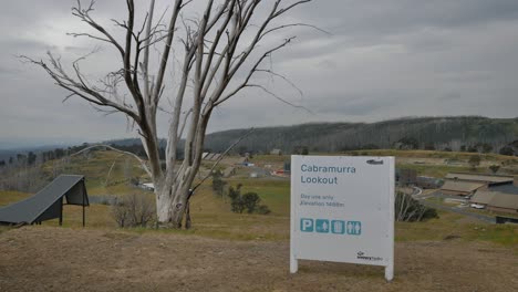 view from cabramurra lookout including signage and town, in the snowy mountains region of new south wales.