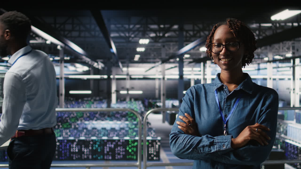 Portrait of smiling data center admin next to coworkers