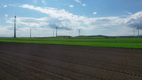 Aerial-low-flying-shot-of-wind-turbines