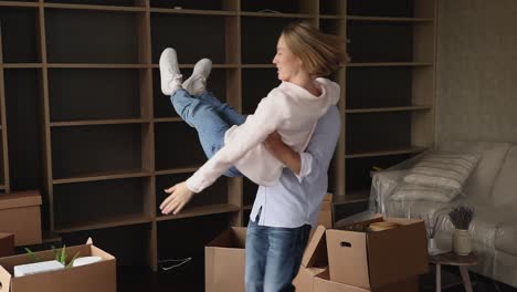 happy homeowner couple dancing in living room celebrate relocation day