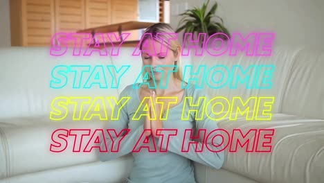 Animation-of-four-lines-of-colourful-neon-words-Stay-At-Home-over-Caucasian-woman-meditating