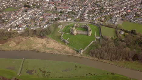 Aerial-footage-of-Rhuddlan-Castle-and-Rhuddlan-town-on-a-sunny-day,-Denbighshire,-North-Wales