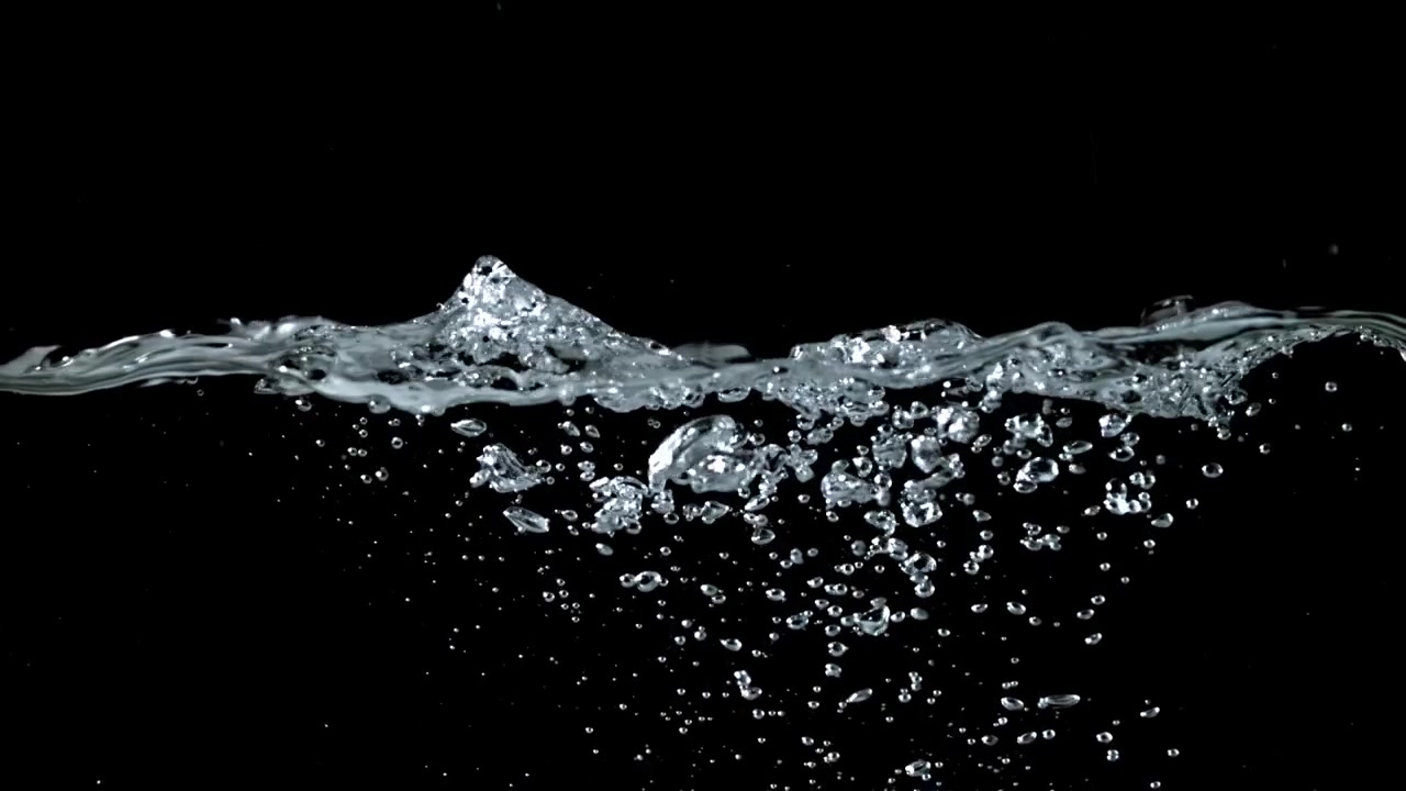 Clear Water Surface with Rising Bubbles on Black Background