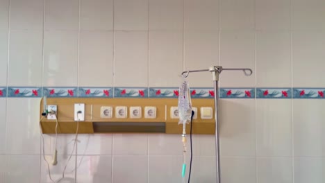 the wall in a hospital with the sockets and a stand for a bag of medical infusion fluid