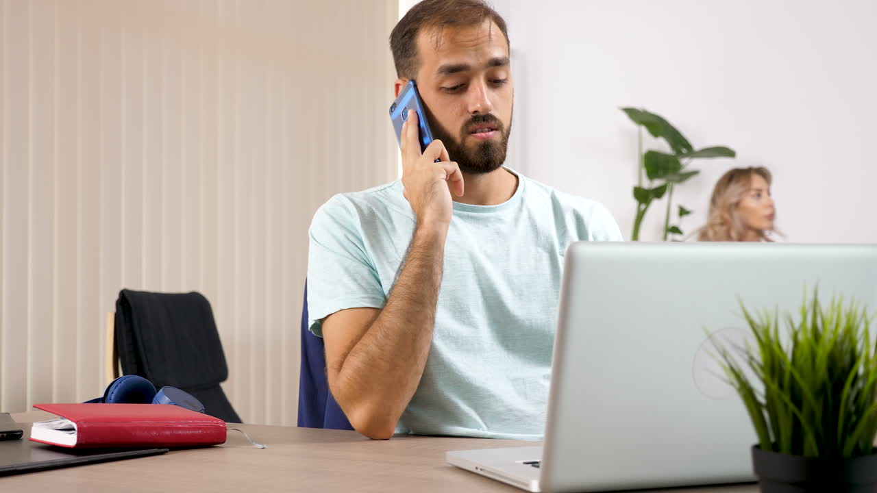 Man on Phone Call While Woman Plays VR Game