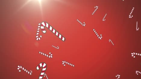 Animation-of-christmas-candy-canes-decorations-falling-with-glowing-light-on-red-background