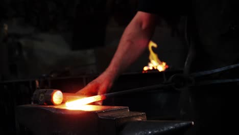 Mid-section-of-blacksmith-working-on-a-iron-rod