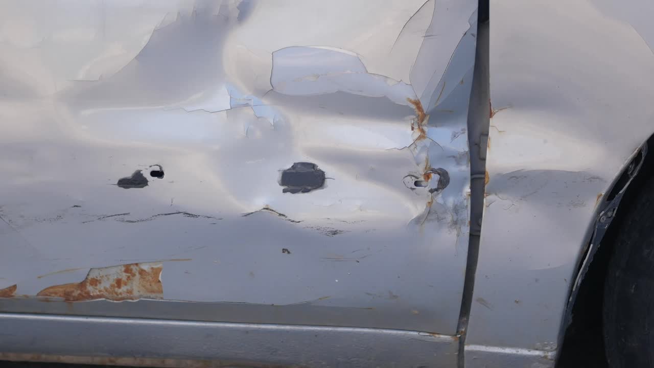 Damaged Car Door with Rust and Dents