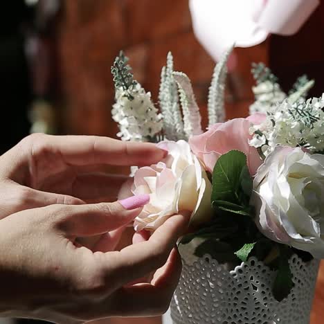 woman arranging beautiful artificial flowers