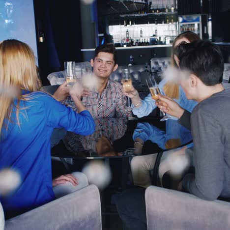 Young-People-Relax-At-A-Table-In-A-Cozy-Restaurant-While-They-Talk-And-Have-A-Good-Time-1