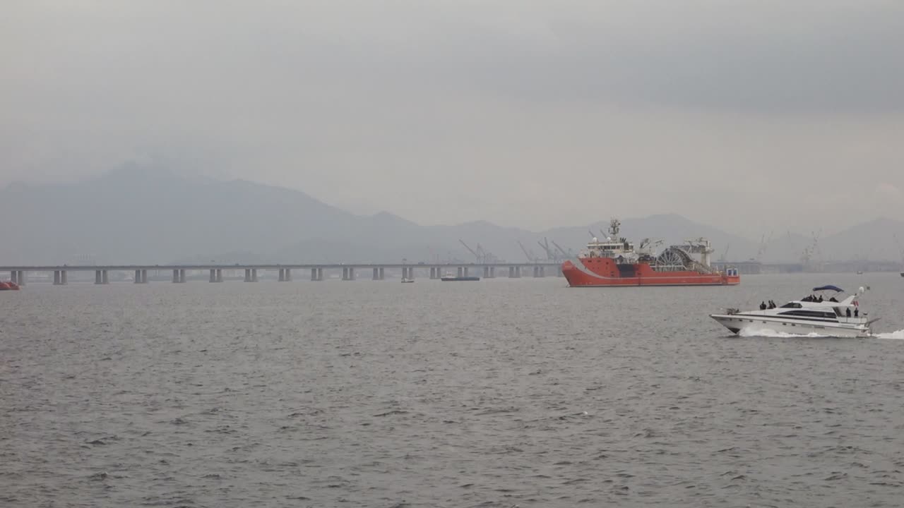 Motor Yacht Cruising At Guanabara Bay With Foggy Background IN Brazil. - wide shot