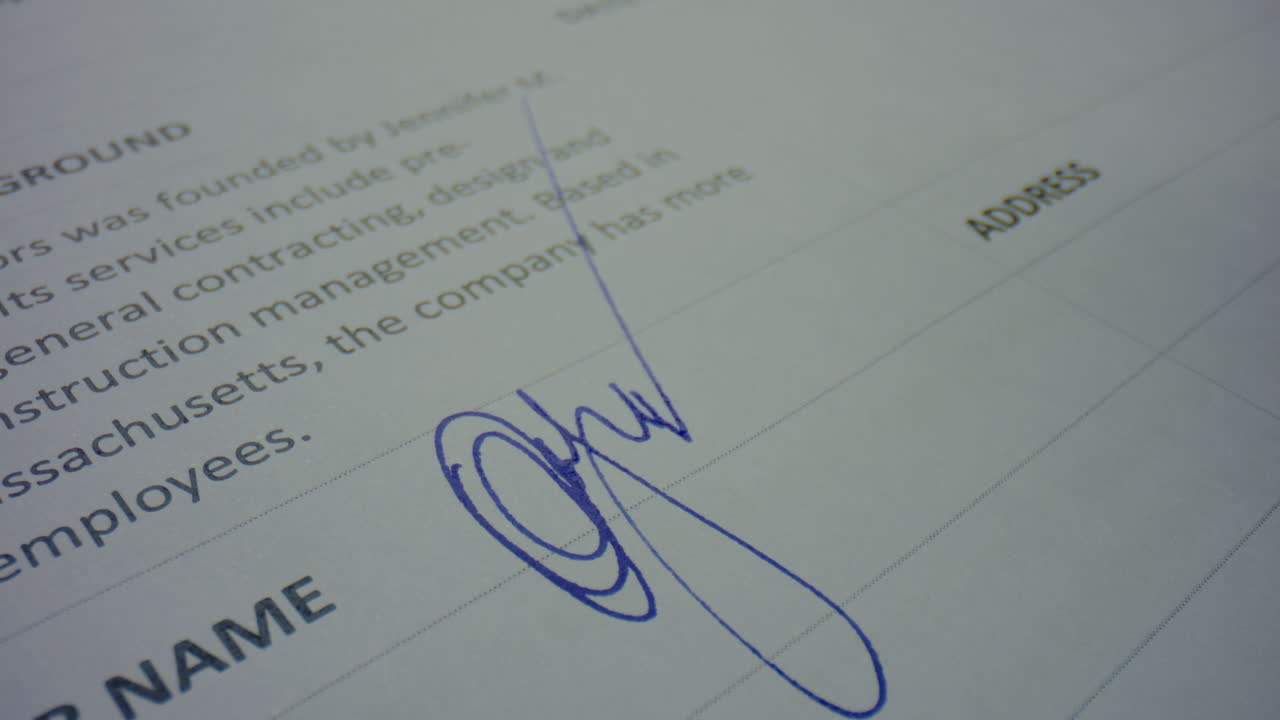 Unknown person signing document with pen