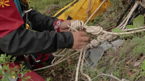 Person-tying-a-knot-with-ropes