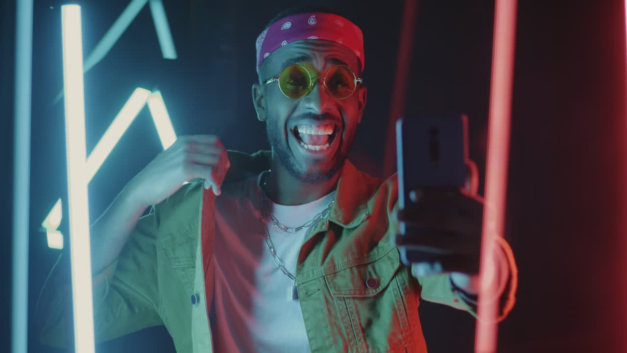 Man taking selfie with neon lights background