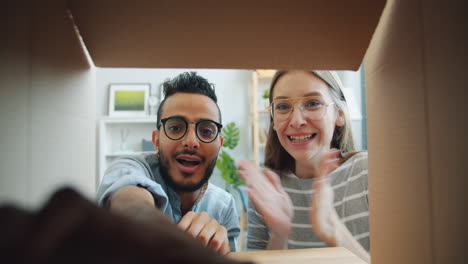 couple excitedly opening a gift box