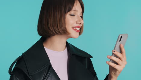 young woman in black jacket using smartphone