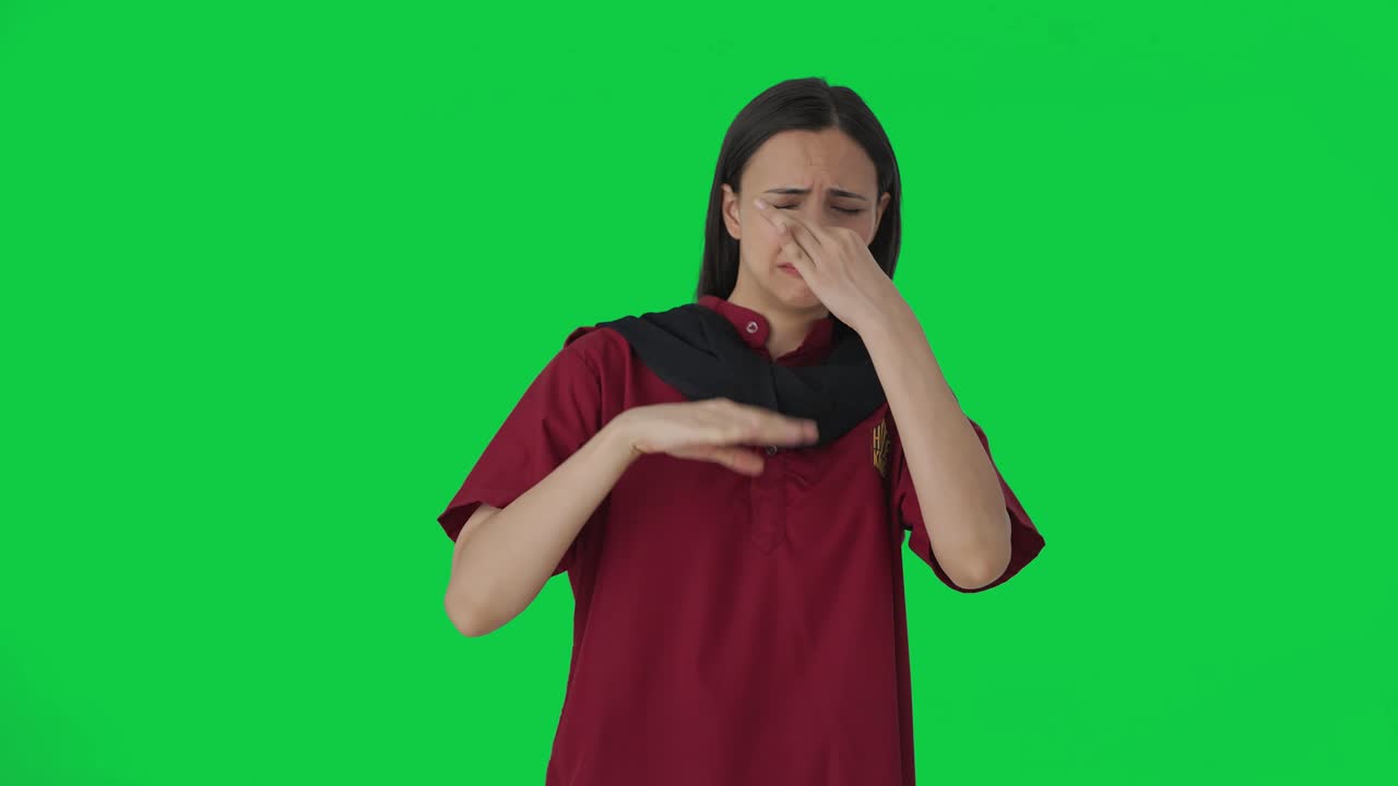 Upset Indian female housekeeper disgusted by bad smell Green screen