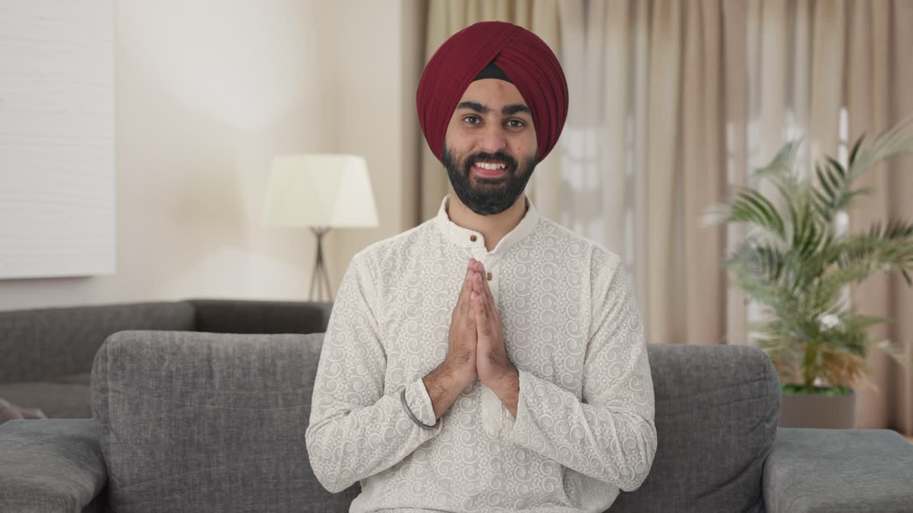 Happy Sikh Indian man doing Namaste