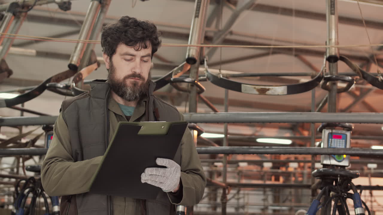 Man Taking Notes in Industrial Premises